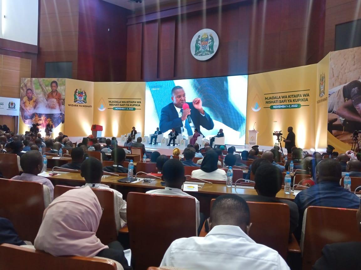 National clean cooking conference in Tanzania, with a full auditorium audience and officials on stage